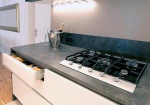 a kitchen with a stove and a counter top at City Pearl Apartment in Ljubljana +17 photos