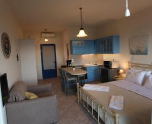 a living room and kitchen with a bed and a couch at Sea Urchin Apartments 2nd floor in Agia Pelagia Kythira