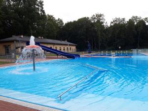a large swimming pool with a water slide at Apartamenty Limanowskiego in Bartoszyce