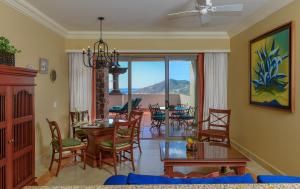 a living room with a dining room table and chairs at Pueblo Bonito Sunset Beach Golf & Spa Resort - All Inclusive in Cabo San Lucas