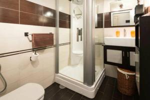 a bathroom with a shower and a toilet and a sink at NORTH CLIFF APARTMENT *The Ocean Beneath your Feet* in Gáldar +29 photos