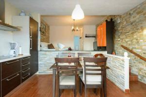 a kitchen with a table and chairs in a room at NORTH CLIFF APARTMENT *The Ocean Beneath your Feet* in Gáldar