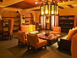 a living room filled with furniture and a bar at Ma'in Hot Springs in Sowayma