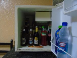 a refrigerator filled with lots of bottles of beer at Hotel Imperial in Guayaquil