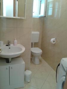 a bathroom with a sink and a toilet at Sea view apartman Antonio in Zadar
