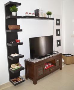 a living room with a tv on a shelf at Casa Mabel in Playa Blanca