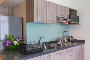 
a kitchen with a stove top oven and a sink at Casa Malí by Dominion Boutique Hotel in Mexico City
