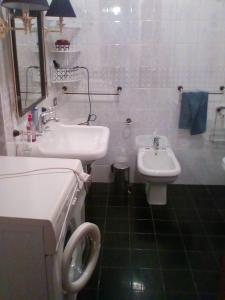 a white bathroom with a sink and a toilet at CASCINA NELLA CAMPAGNA ABRUZZESE in Isola del Gran Sasso dʼItalia