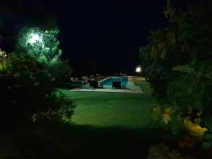 a backyard at night with a swimming pool at Terre Di Vendicari in Noto