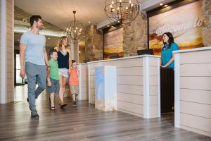 a family walking down a hallway in a mall at Margaritaville Lake Resort Lake of the Ozarks in Osage Beach +24 photos