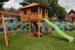 a playground with a tree house and a slide at BESKIDZKA CHAŁUPKA in Łękawica