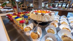 a table with a cake and plates of desserts at TUI Blue Isla Cristina Palace - Adults Recommended in Isla Cristina