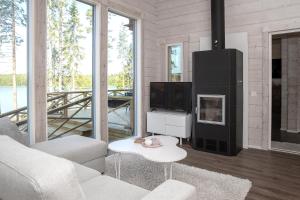 a living room with a couch and a tv at Villa Leponiemi in Keuruu