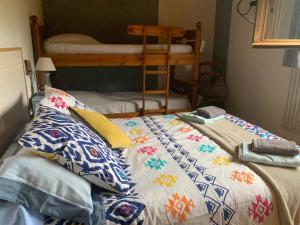 a bed in a room with a bunk bed at L'Eterle des Bauges in Aillon-le-Jeune