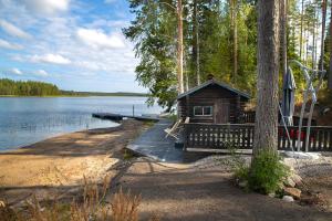a log cabin on a dock next to a lake at Villa Leponiemi in Keuruu