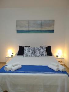 a bedroom with a large bed with two towels on it at La Casa di Bianca in Caltagirone