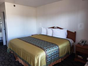 a hotel room with a bed in a room at Super 7 Inn in Memphis