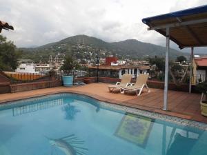 a swimming pool with a view of a city at Casa Paanoramica in Valle de Bravo