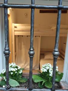 a metal bed with flowers on the bottom of it at Chez Rosine in Saint-Sauveur-sur-Tinée