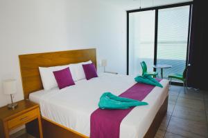 Postel nebo postele na pokoji v ubytování Yuum Ha Boutique Hotel