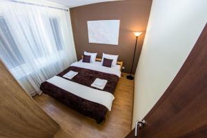 a hotel room with a bed and a window at Panorama View Belgrade in Belgrade