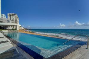 a swimming pool with a view of the ocean at Condado Ocean Club - Adults Only in San Juan