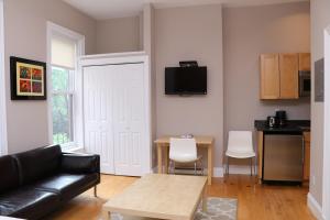 a living room with a couch and a table at Charming Studio in Boston Brownstone, #6 in Boston