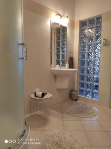 a bathroom with a sink and a mirror at Hanga Apartman, Kőszeg in Kőszeg