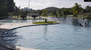 a large swimming pool with people in the water at Iloa Residence Resort - Barra de São Miguel in Barra de São Miguel +6 photos