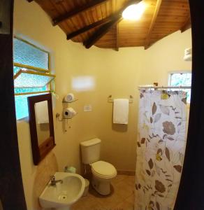 a bathroom with a toilet and a sink at Pousada Spa Prana Lorien in Santo Antônio do Leite