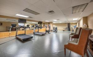 a gym with treadmills and elliptical machines and chairs at Silverado Lodge Two Queen Hotel Room by Canyons Village Rentals 223C in Park City