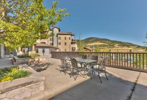 a patio with a table and chairs and a fence at Silverado Lodge Two Queen Hotel Room by Canyons Village Rentals 223C in Park City