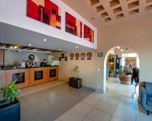 a lobby of a restaurant with a bar at Baja Inn Hoteles Ensenada in Ensenada