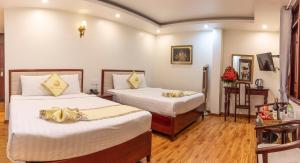 Ένα ή περισσότερα κρεβάτια σε δωμάτιο στο Thanh Do Hotel