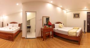 Ένα ή περισσότερα κρεβάτια σε δωμάτιο στο Thanh Do Hotel