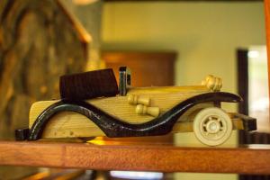 a wooden toy car sitting on top of a book at Cocos Cabañas Playa del Carmen Adults Only in Playa del Carmen