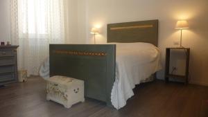 a bedroom with a large bed and a dresser at Al Pergolesi B&B in Iesi