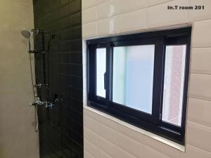 a bathroom with a window and a shower at In.T in Tainan +40 photos