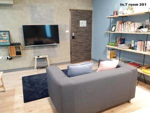 台南的住宿－In.T ，带沙发和平面电视的客厅