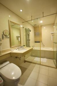 a bathroom with a toilet and a sink and a shower at Rich Garden Hotel in Taipei