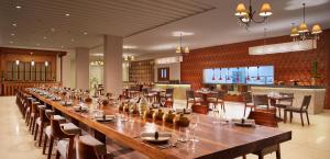 a large dining room with a long table and chairs at MERUSAKA Nusa Dua in Nusa Dua