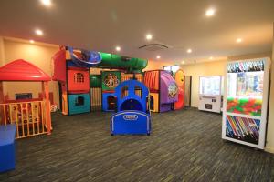 a childrens play room with a slide and rides at Hogans Motel in Wallan