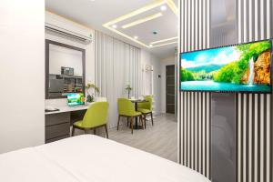 a hotel room with a flat screen tv on a wall at My Suites Danang Beach in Danang