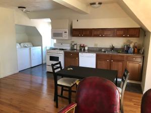 a kitchen with a table and chairs in a room at Highland Park Pittsburgh in Pittsburgh