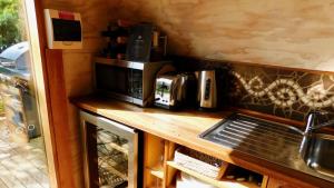a kitchen with a stove top oven and a coffee maker at 43 Degrees Bruny Island in Adventure Bay