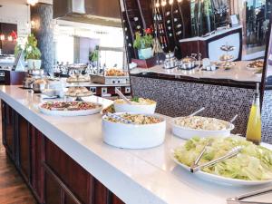 a buffet line with many different dishes of food at Blue Waters Hotel in Durban