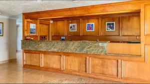 a lobby with a large counter in a building at Motel 6-Alvin, TX in Alvin