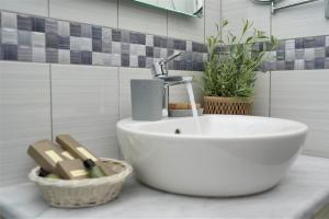 a bathroom sink with a faucet on a counter at Vigla Hotel in Aegiali