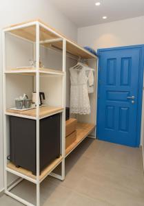 a walk in closet with a blue door at Vigla Hotel in Aegiali