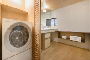 a laundry room with a washing machine and a sink at Kyo no Ondokoro NISHIJIN VILLA #5 in Kyoto +56 photos